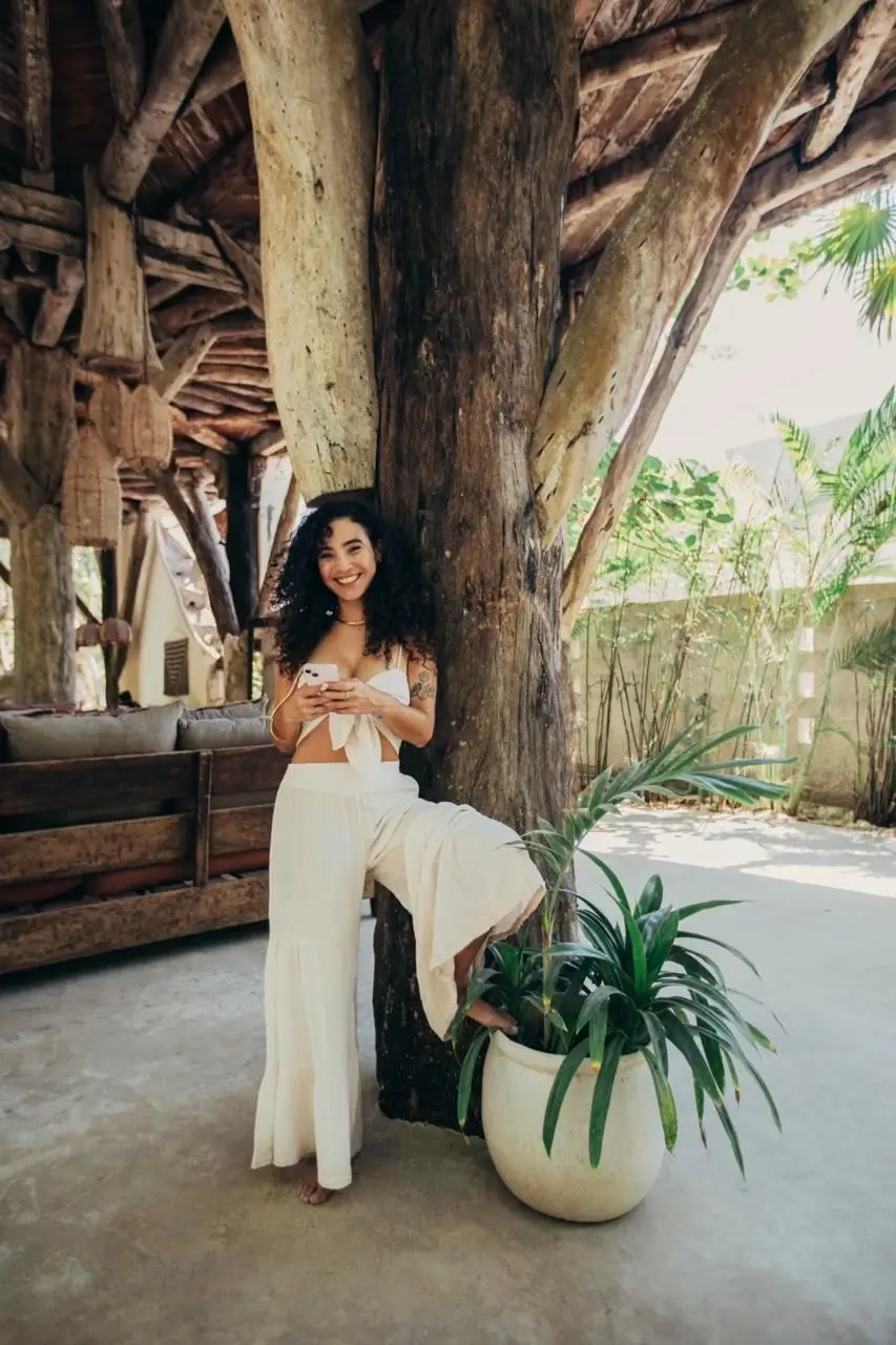 Smiling Tulum wedding planner in a relaxed boho setting.